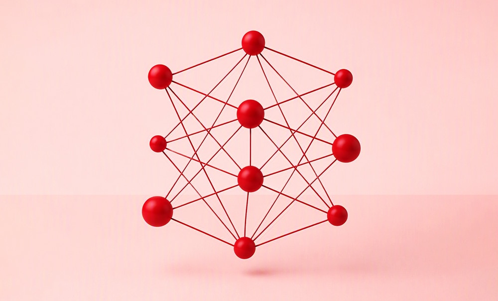 Abstract neural network graphic composed of interconnected red spheres and lines on a light pink background.