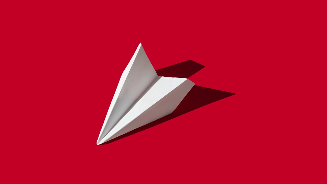 Image of paper plane on red background