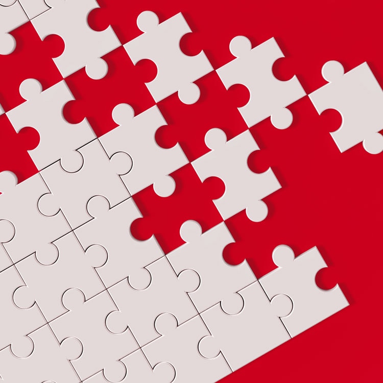 white puzzle pieces on red background