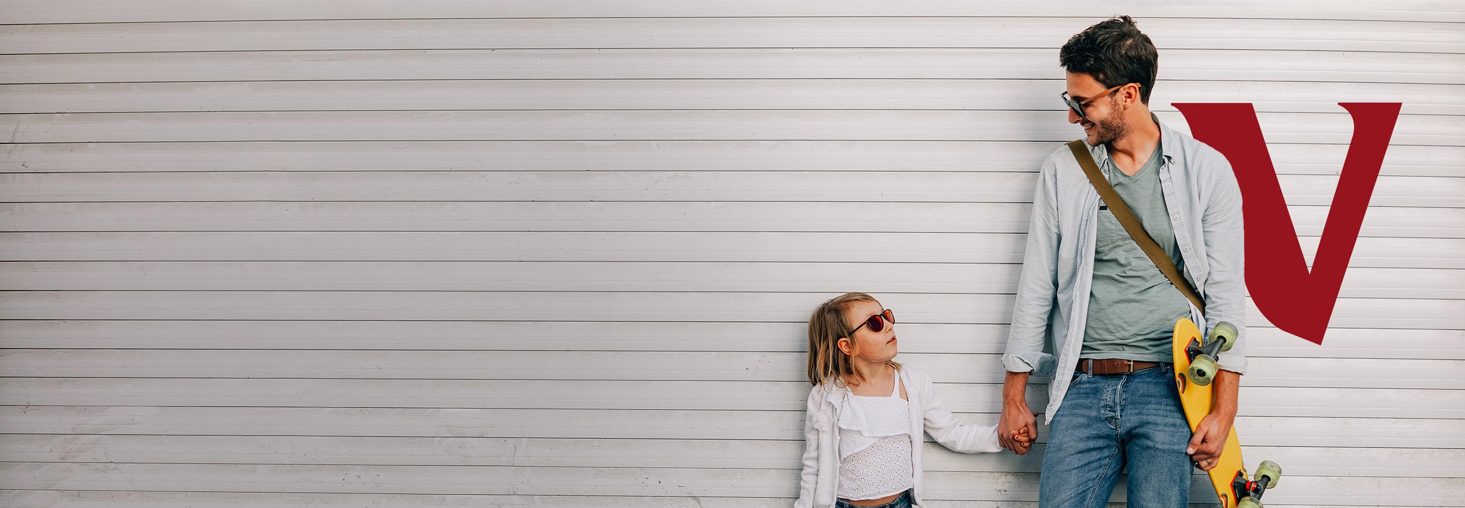 father and daughter holding a skateboard