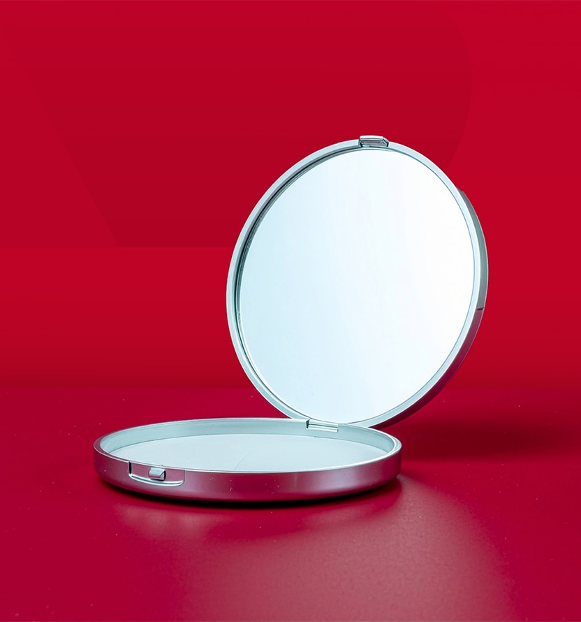 mirror compact on red background