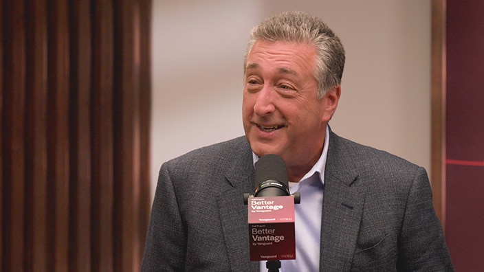 Image of Barry Ritholtz speaking into a microphone with a "Better Vantage by Vanguard" microphone flag.