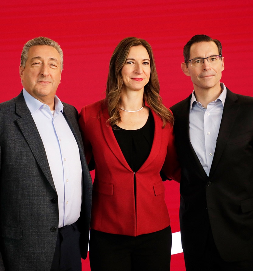 Barry Ritholtz (left), Rebecca Choo Quan (center), and Joe Davis (right) standing side by side in front of a red background.