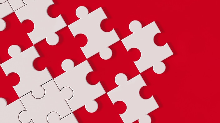 white puzzle pieces on red background